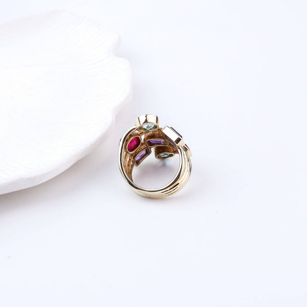 Angled view of a brass fashion ring highlighting its distinctive shape, structure, and polished brass finish