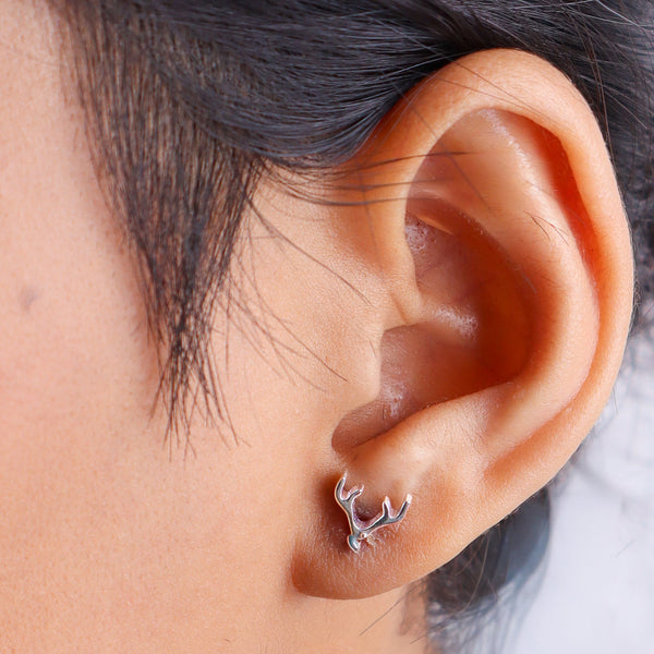 Earrings on woman's ear with black hair