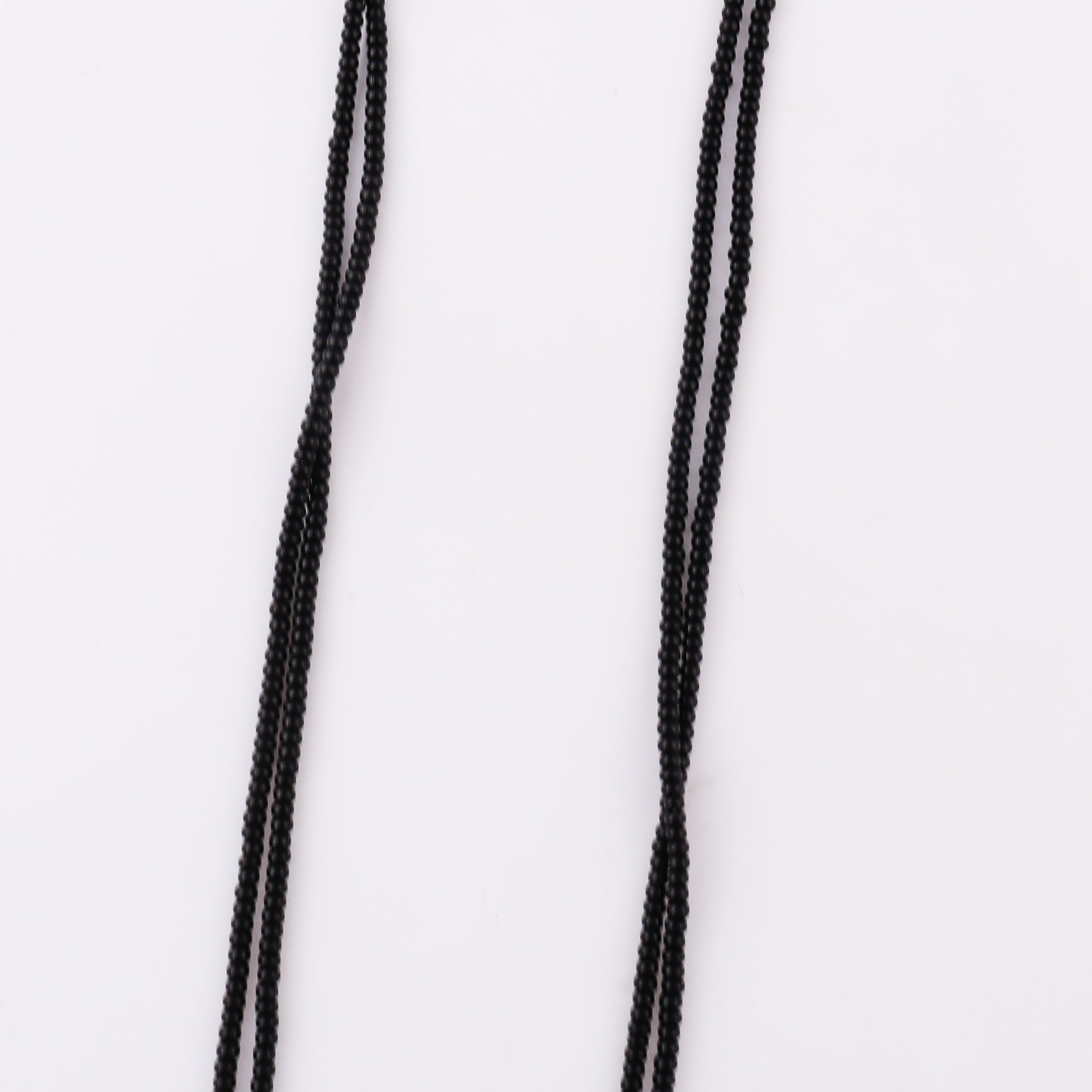 Black beaded necklace with gold pendant hanging