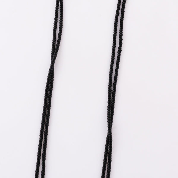 Black beaded necklace with gold pendant hanging