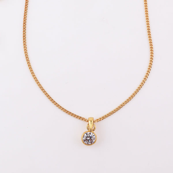 Close-up of gold chain with black cubic zirconia pendant