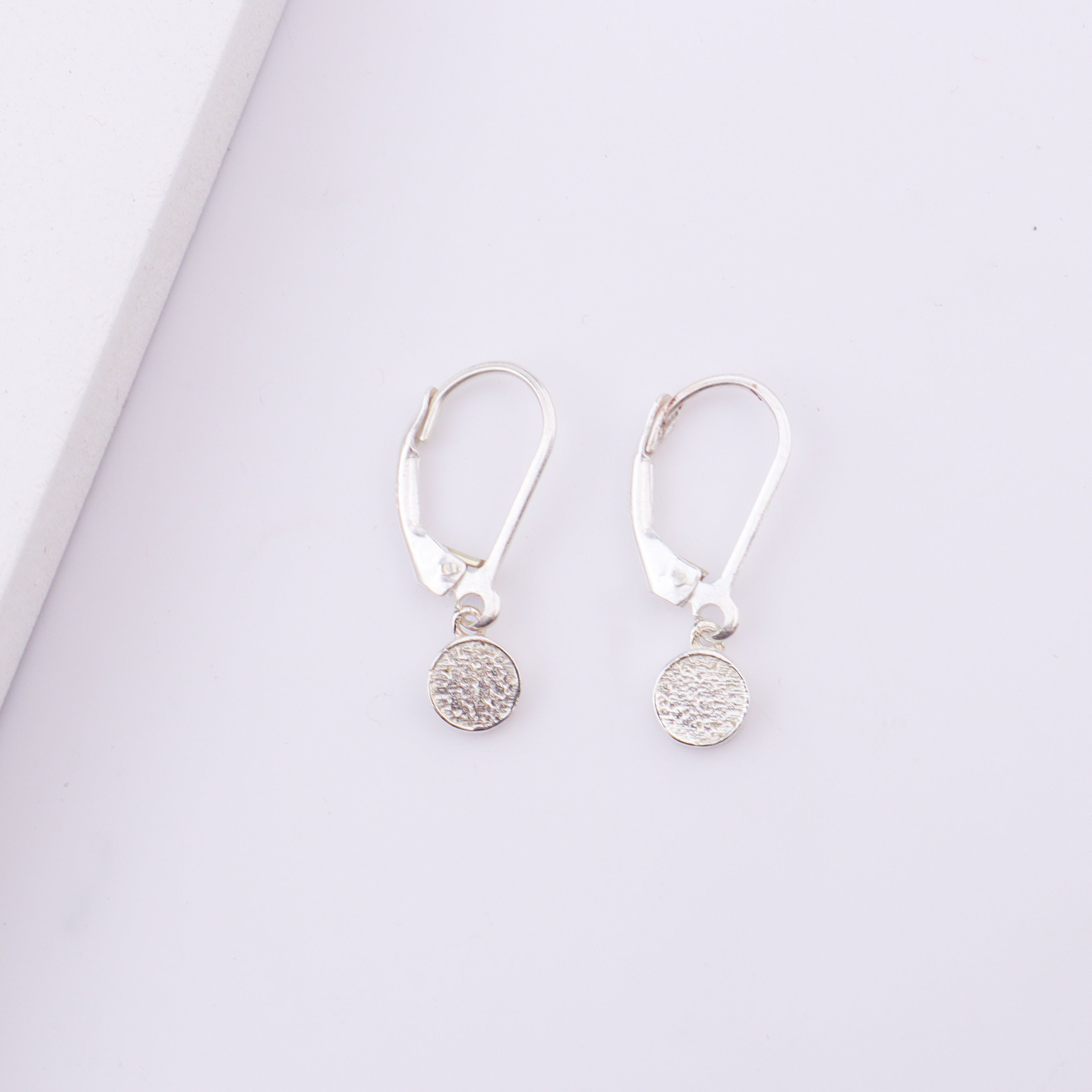 Woman wearing silver Druzy earrings