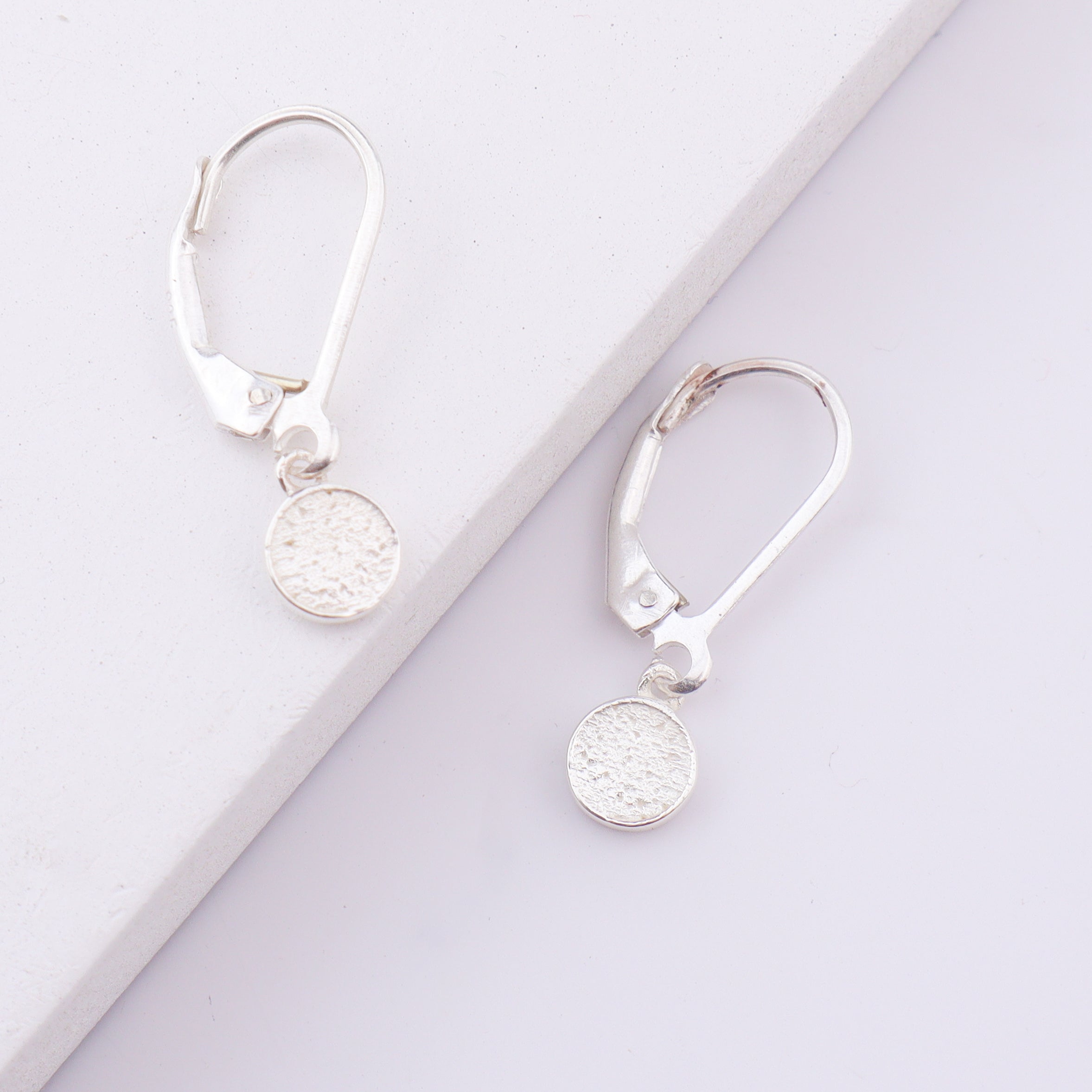Silver earrings with textured round pendant