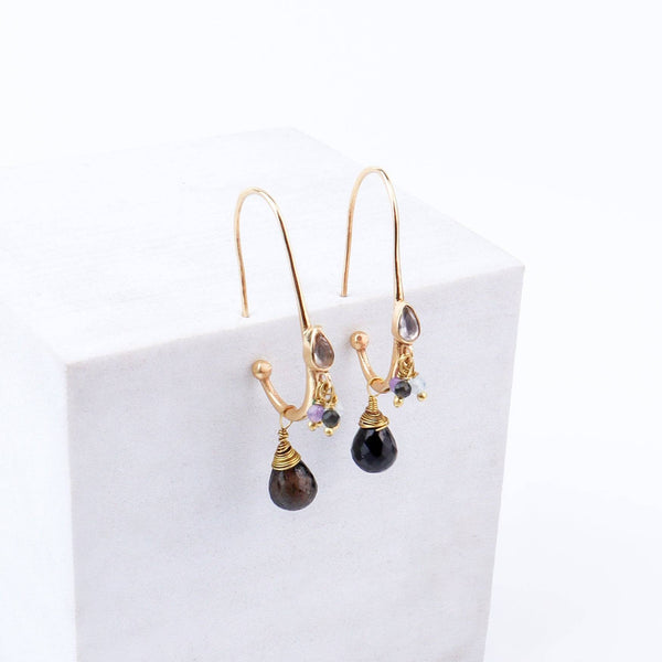 Close-up of brass fashion earrings showcasing intricate detailing, textured elements, and fine craftsmanship