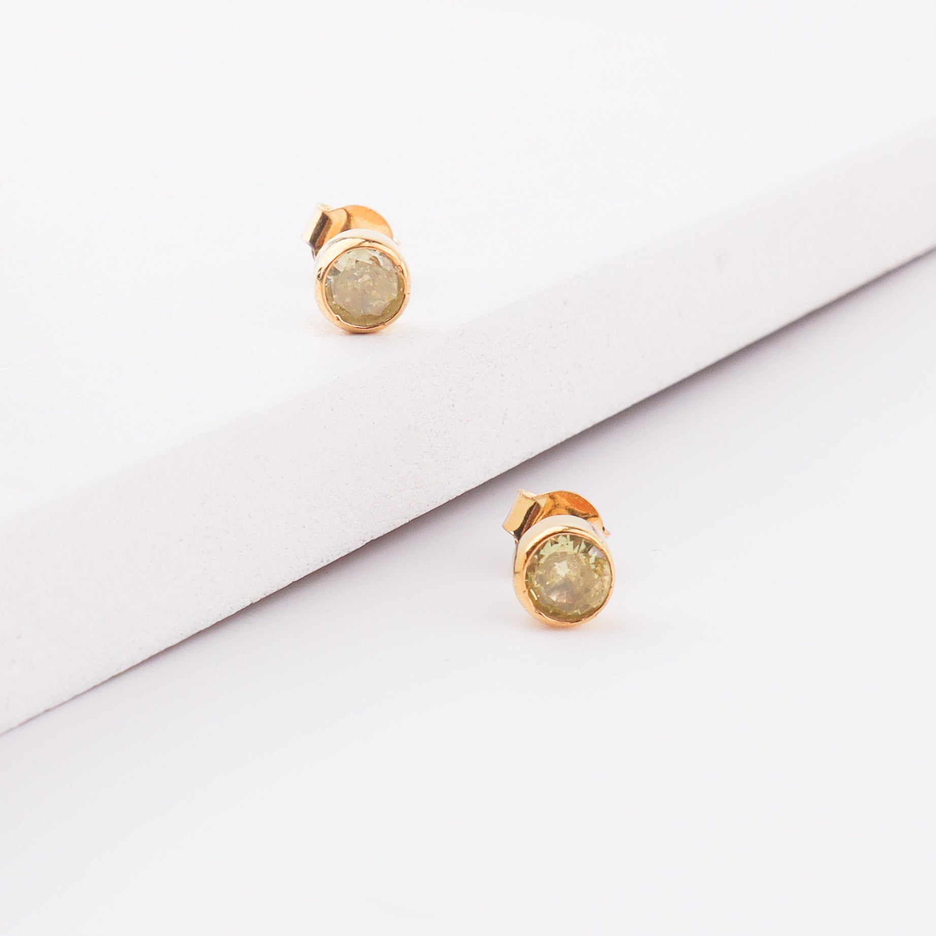 Purple gemstone stud earring with gold setting
