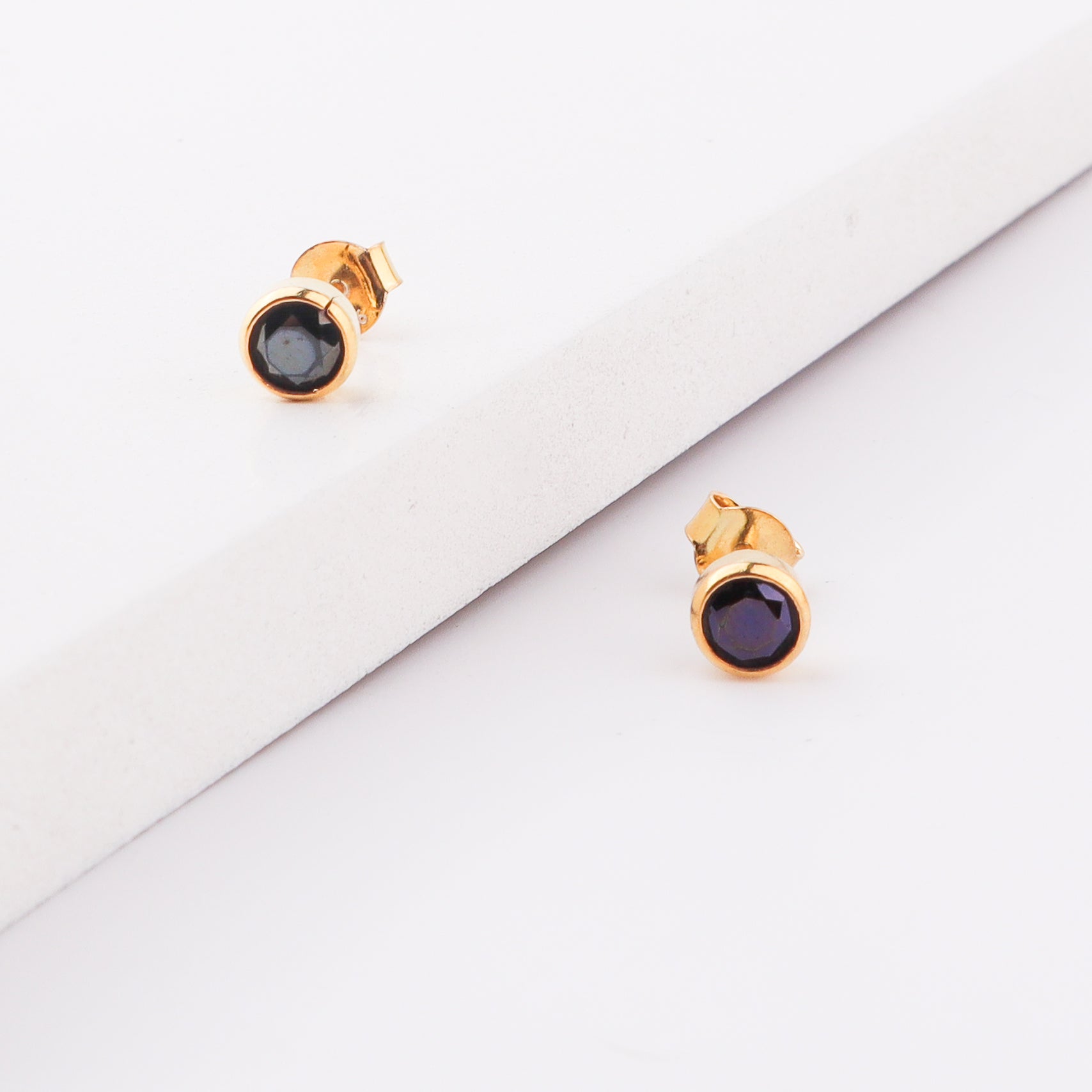 Gold and black gemstone stud earrings
