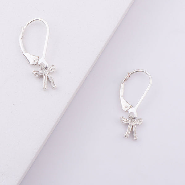 Silver bow earrings on white background
