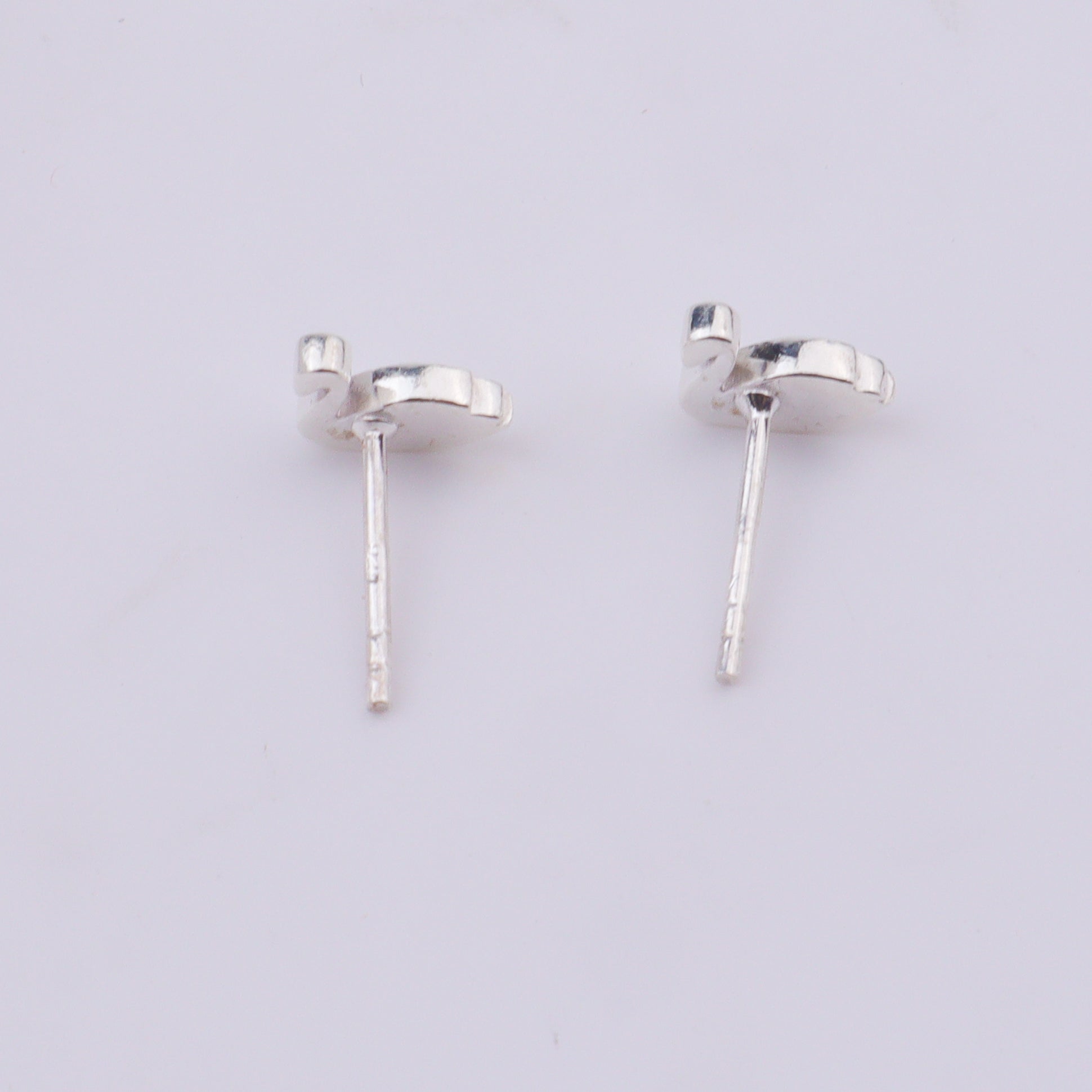 Silver swan earrings on a white background