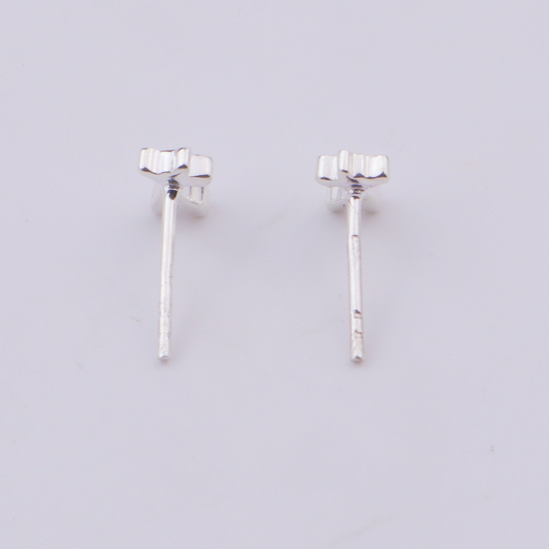 Silver giraffe earrings on white background