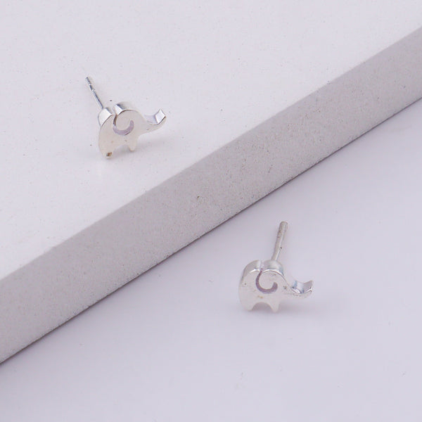Close-up of silver elephant stud earrings on display