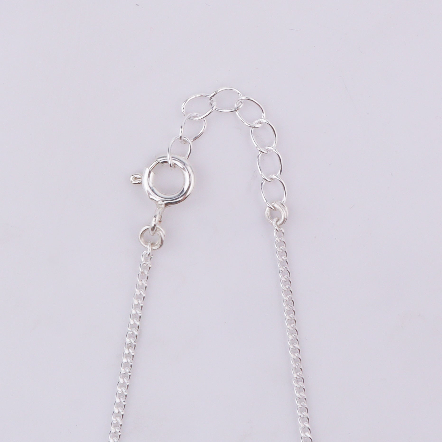 Silver chain with bow pendant clasp detail