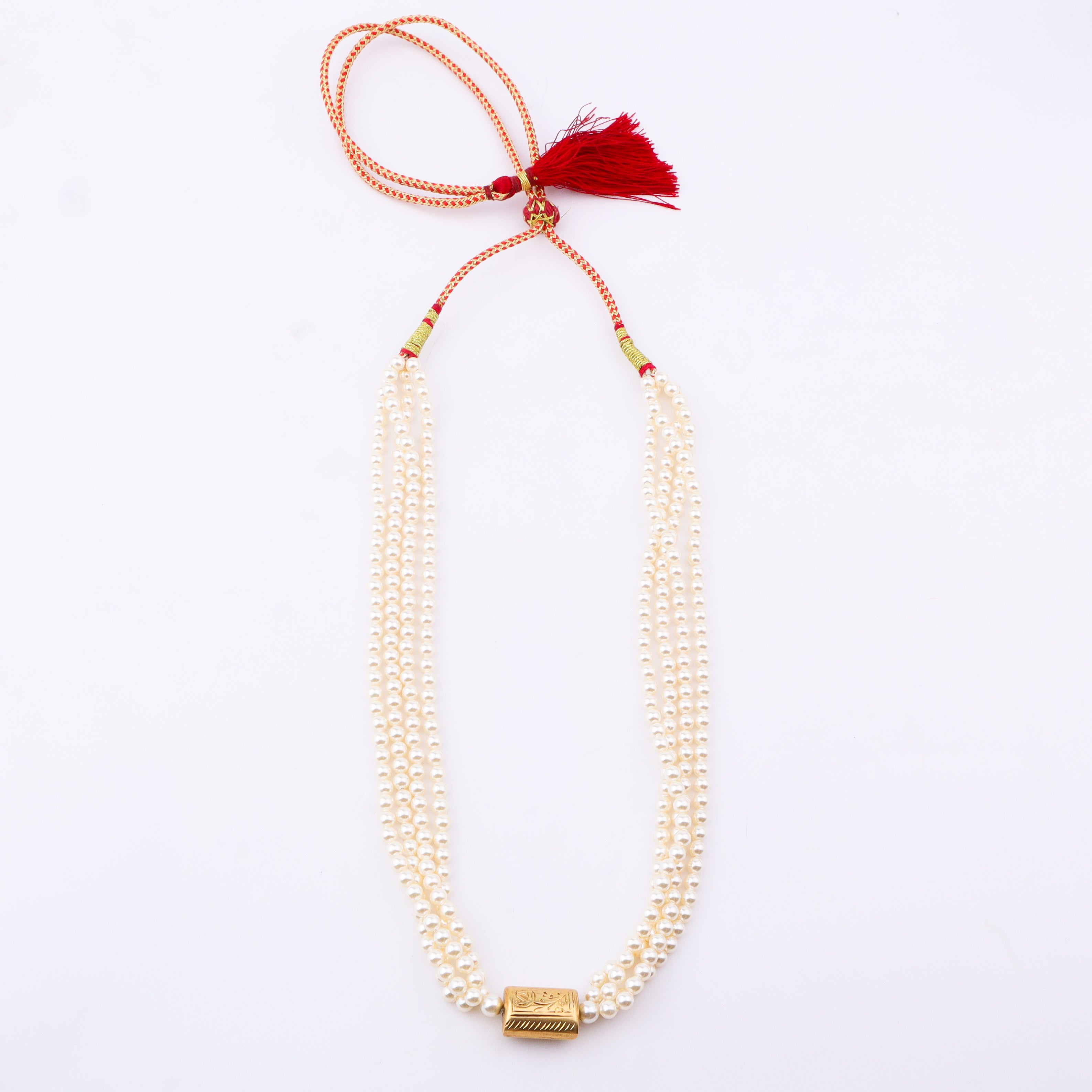 Close-up of pearl necklace with gold clasp on white background