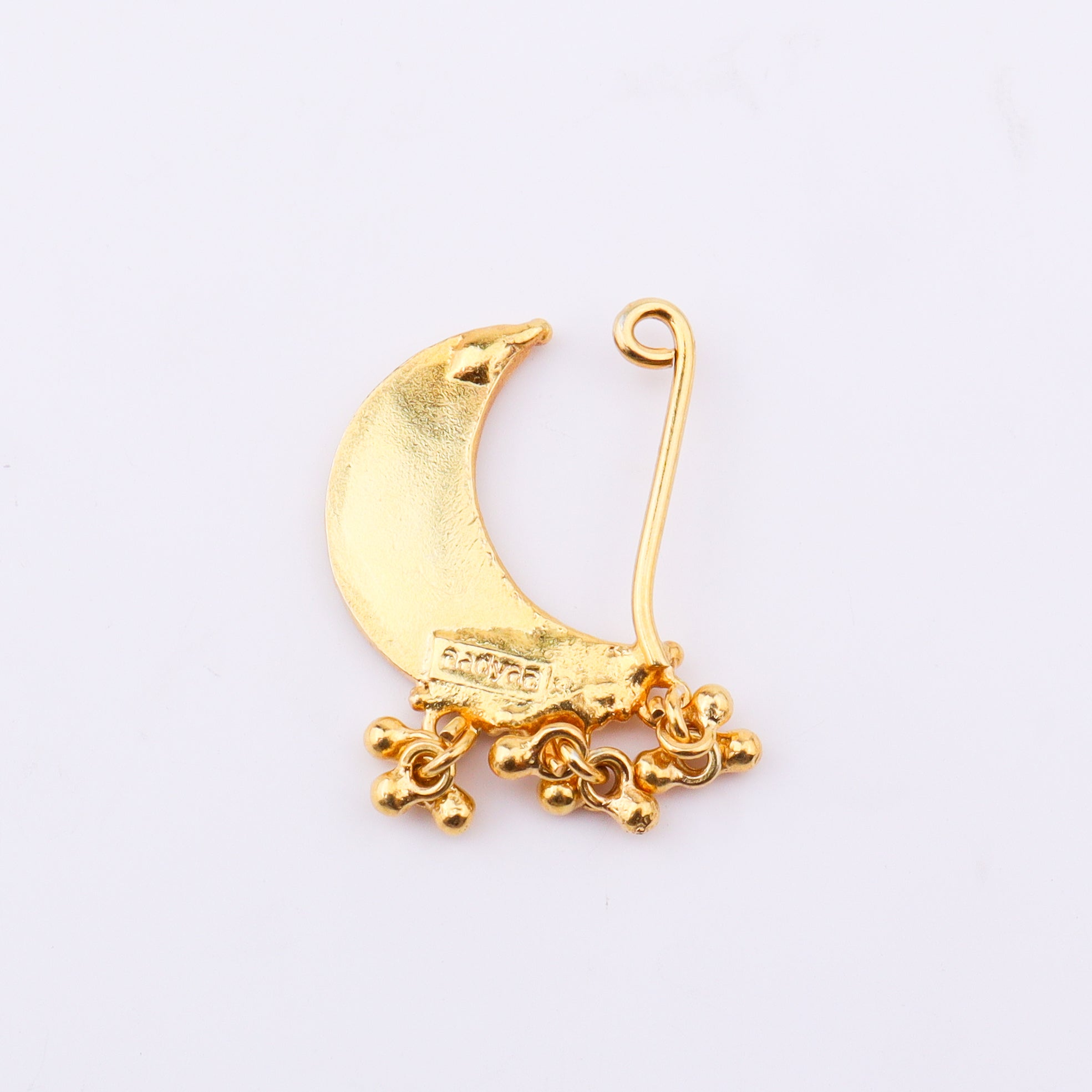 Gold crescent moon earring with chains on white surface