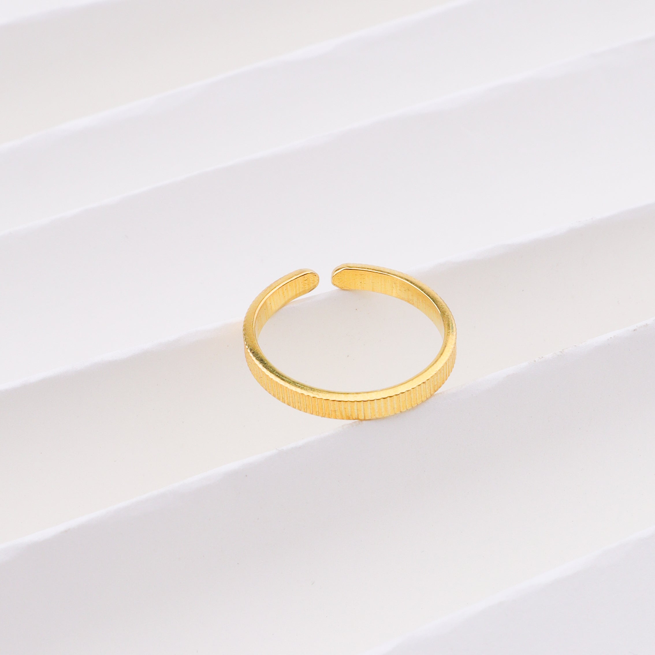 Plain gold ring on white background