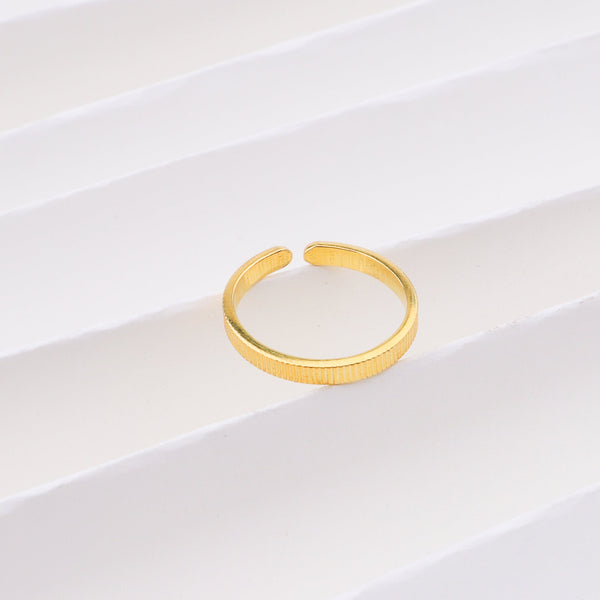 Plain gold ring on white background