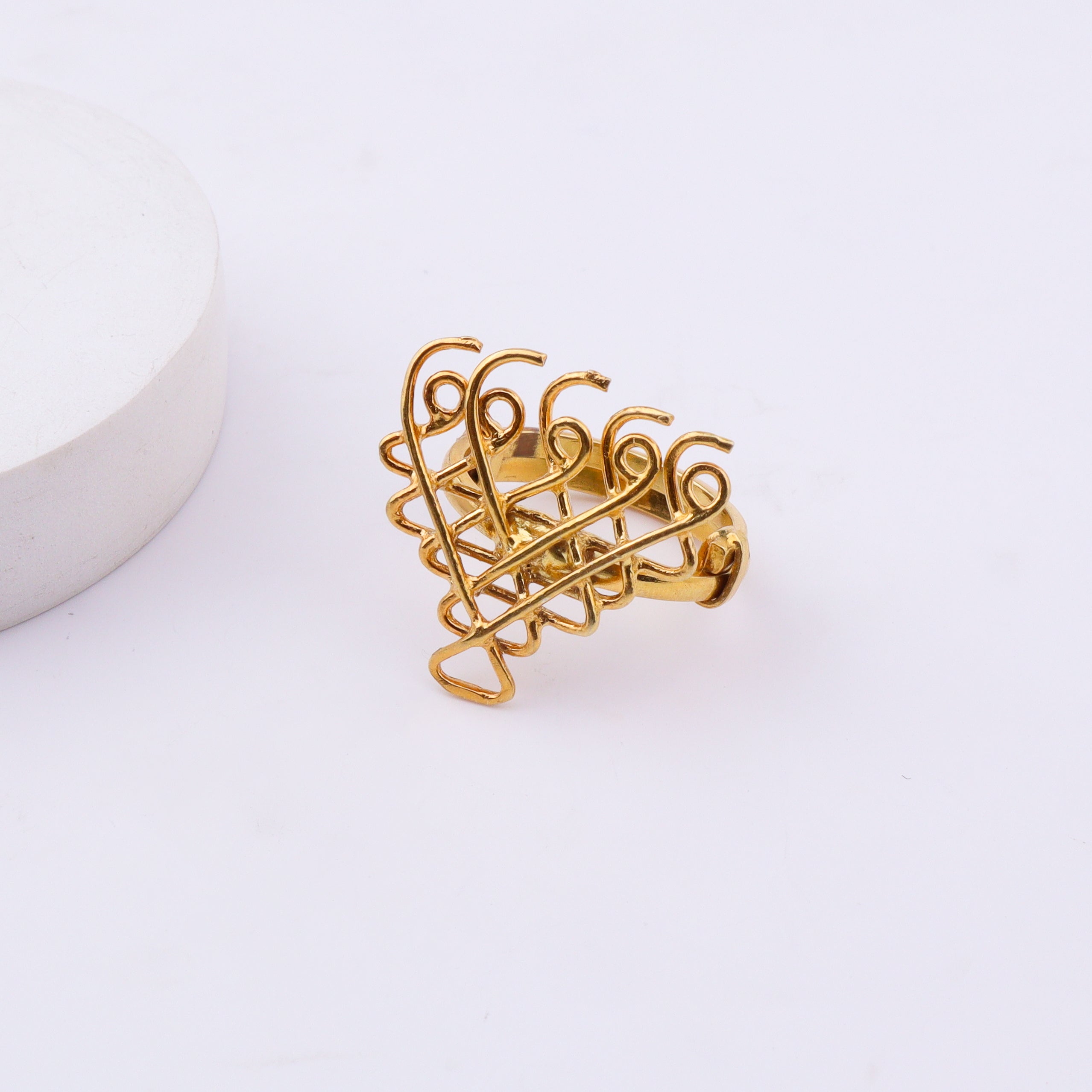 White background with gold plated Saraswati ring