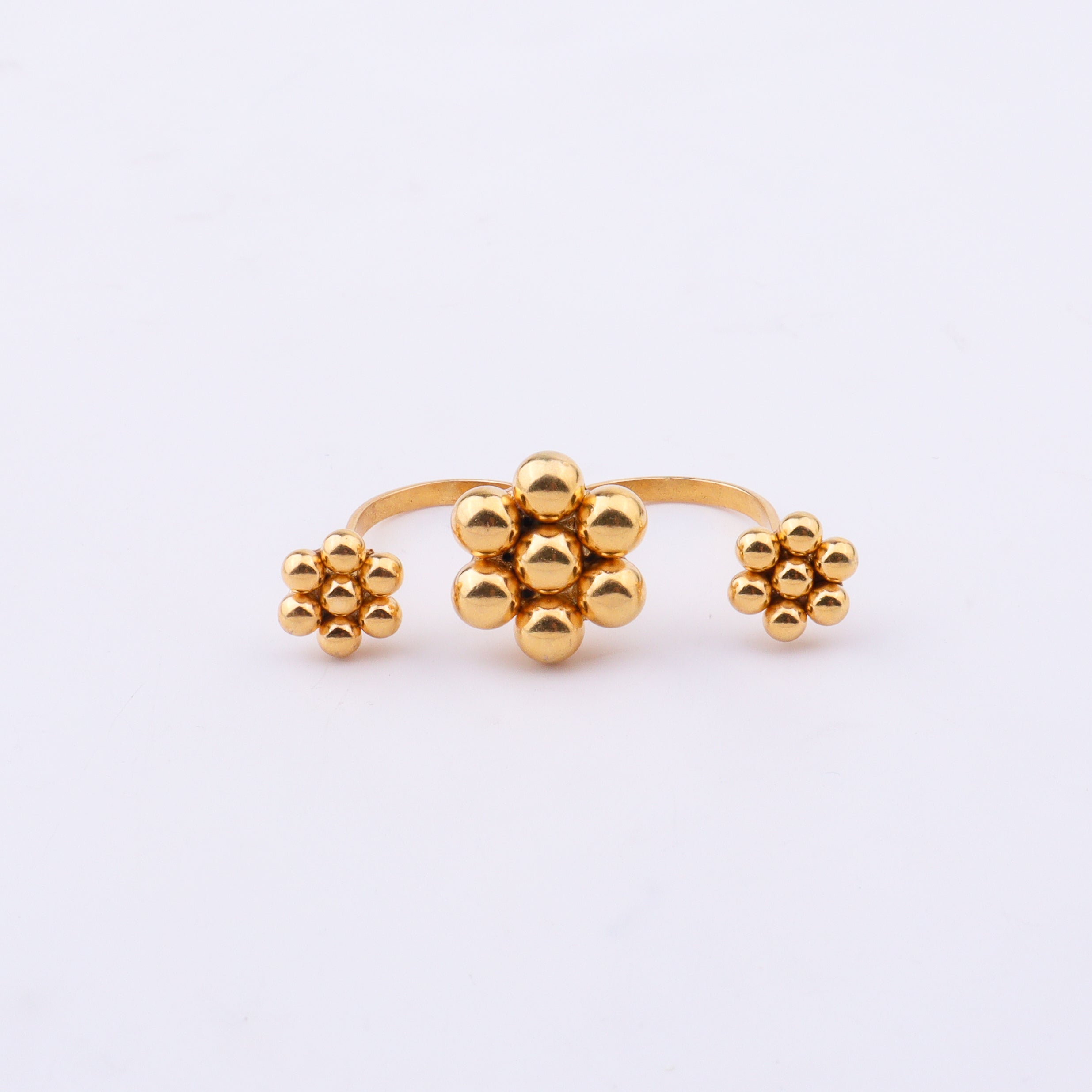 Gold plated floral cluster ring on white background