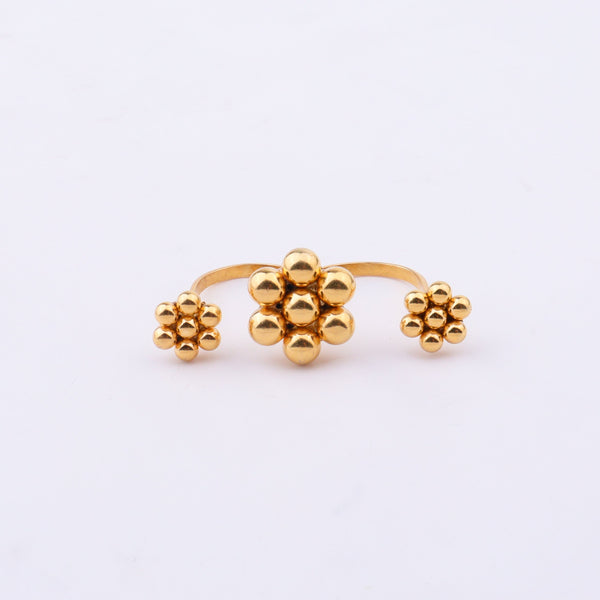 Gold plated floral cluster ring on white background