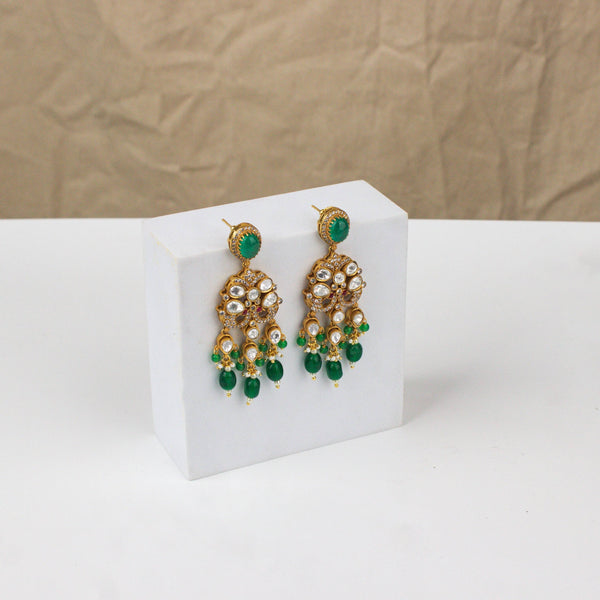 Angled view of a 22K gold-plated fashion earring highlighting its elegant silhouette, structure, and polished gold finish