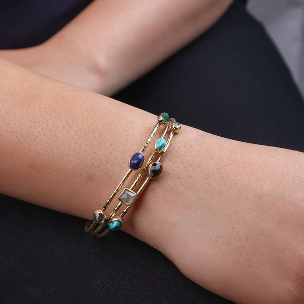 Model wearing a brass fashion bracelet for a stylish and contemporary fashion jewellery look