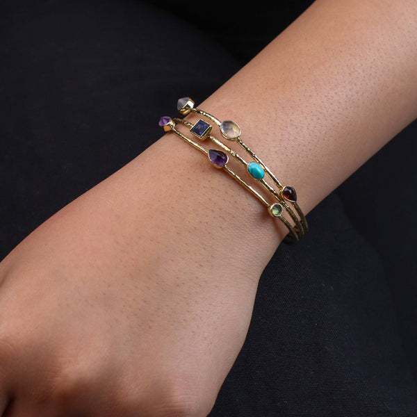 Model wearing a brass fashion bracelet for a stylish and contemporary fashion jewellery look