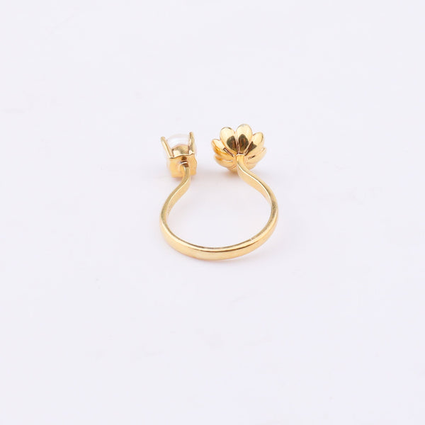 Gold floral ring with pearl on white background