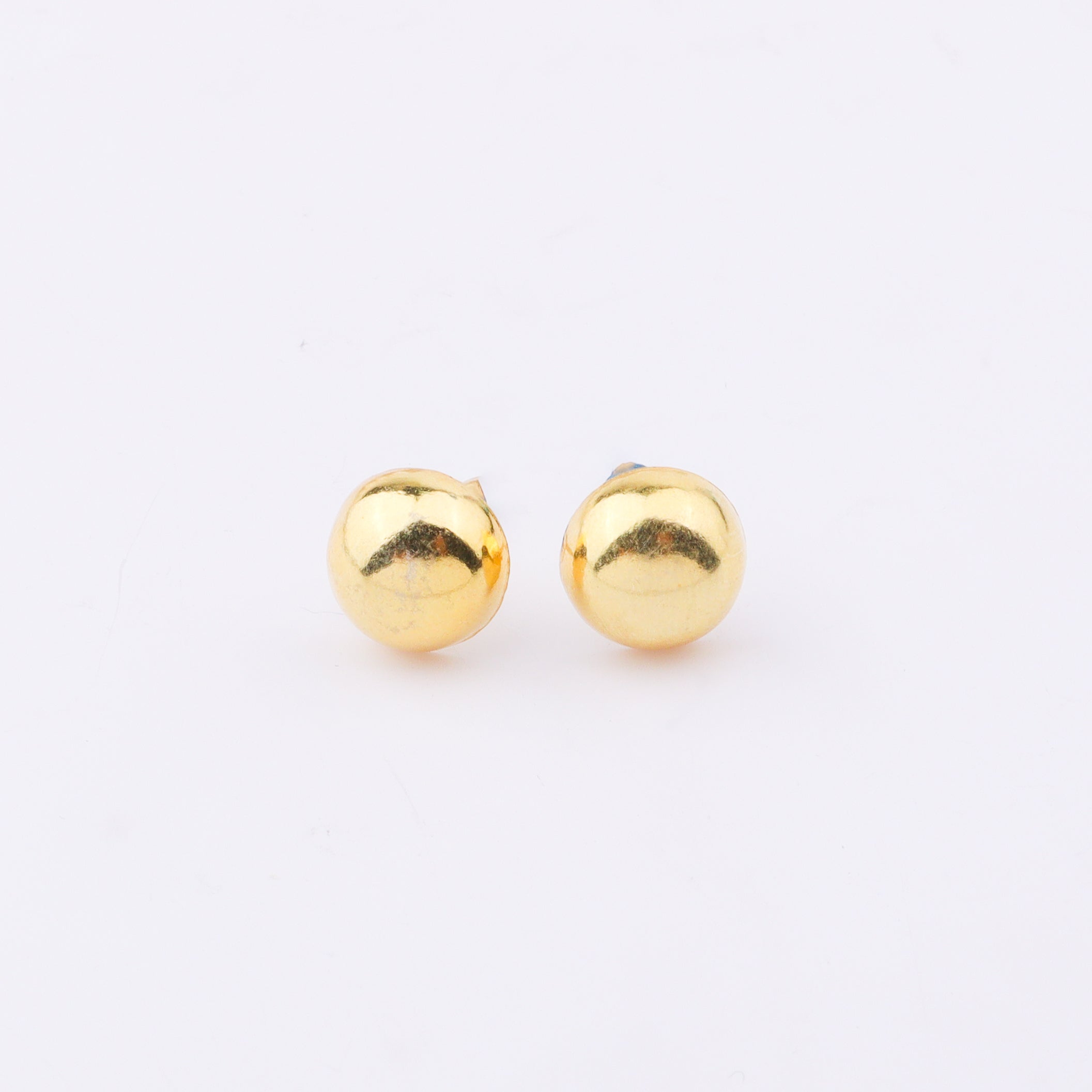 Gold earrings with white background and shadow