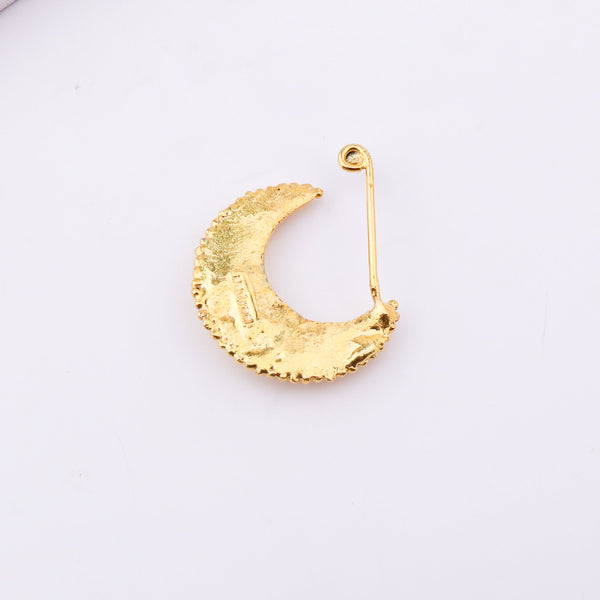 Gold plated crescent moon jewelry with beaded detail on white background