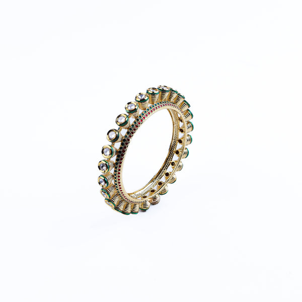 Angled view of a 22K gold-plated fashion bangle (single) highlighting its elegant structure, unique design, and polished gold finish
