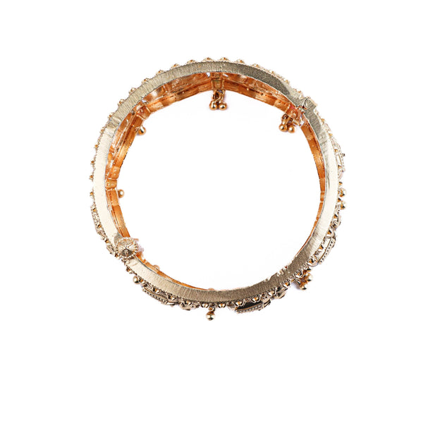 Flat-lay of 22K gold-plated fashion bangle (single) with complementary gold-plated jewelry and elegant accessories