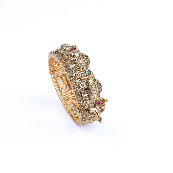 Angled view of a 22K gold-plated fashion bangle (single) highlighting its elegant structure, unique design, and polished gold finish