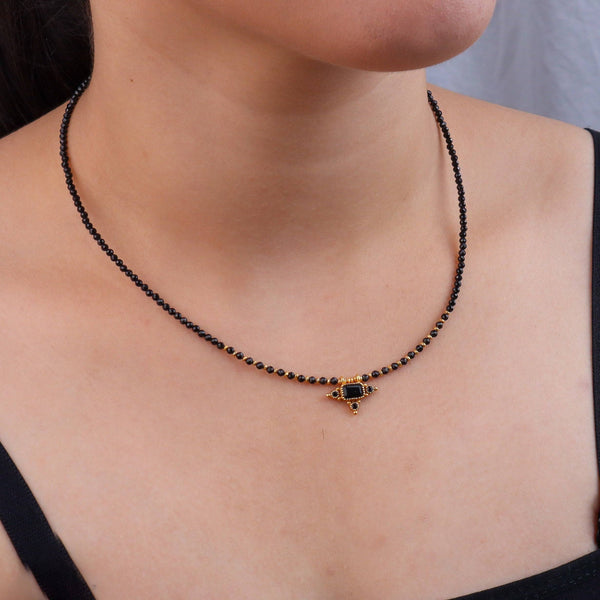 Model wearing a brass fashion necklace for a stylish and contemporary fashion jewellery look