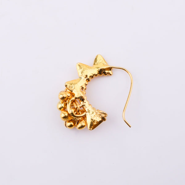 Gold star-shaped nose ring with beaded details on white background