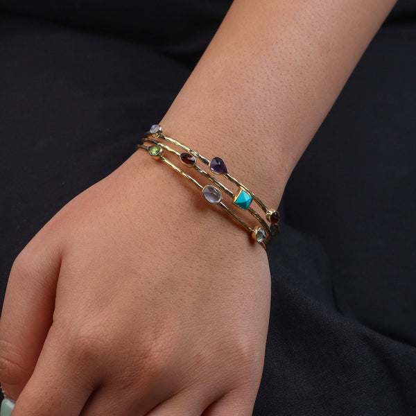 Model wearing a brass fashion bracelet for a stylish and contemporary fashion jewelry look