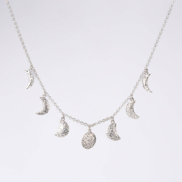 Model wearing silver moon phase necklace for minimalist everyday or festive styling