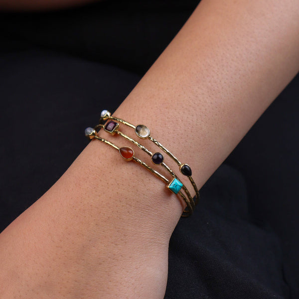 Model wearing a brass fashion bracelet for a stylish and contemporary fashion jewellery look