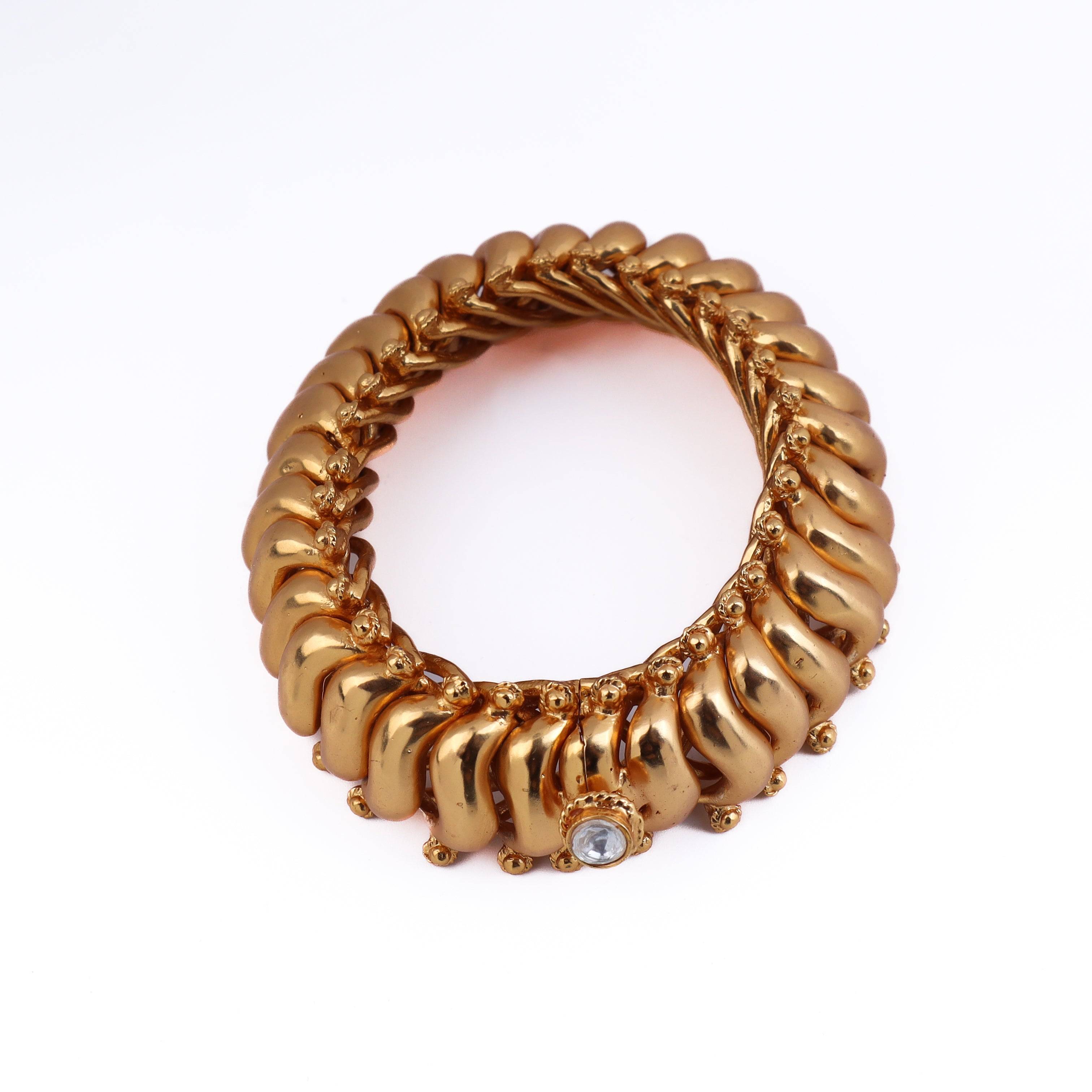 Angled view of 22K gold-plated fashion bangle (single) highlighting its elegant structure and polished gold finish