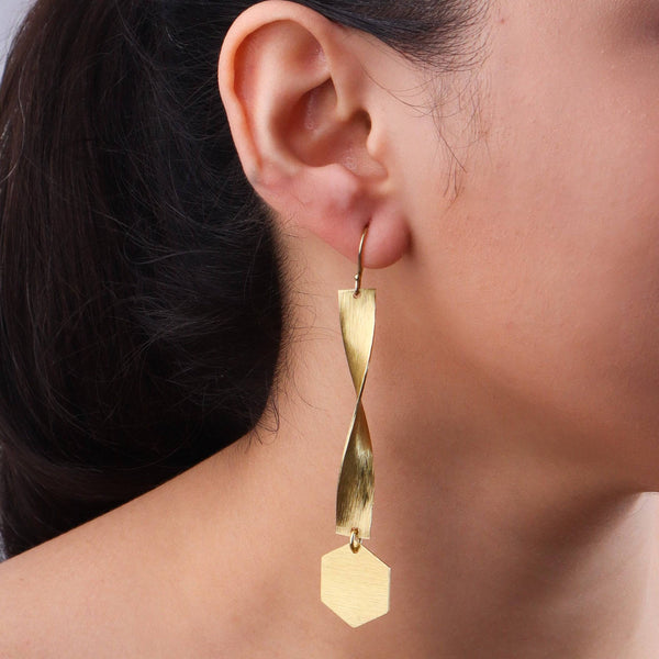 Model wearing brass fashion earrings for a stylish and contemporary fashion jewelry look