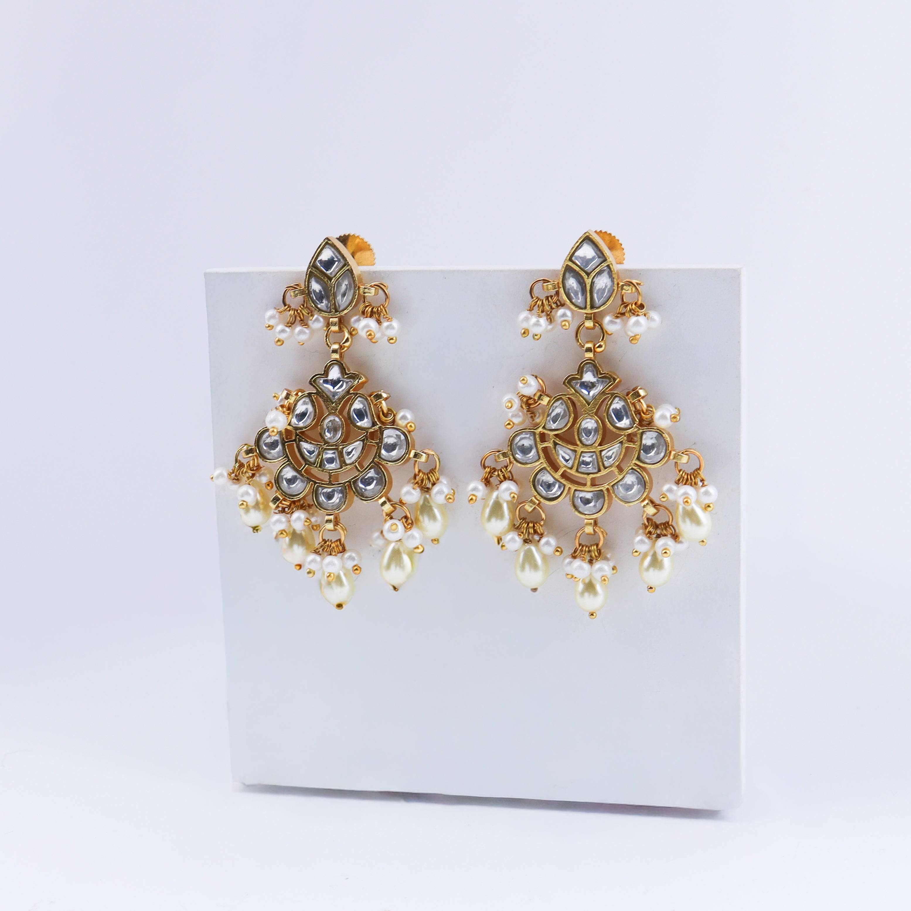 Angled view of a 22K gold-plated fashion earring highlighting its elegant silhouette, structure, and polished gold finish