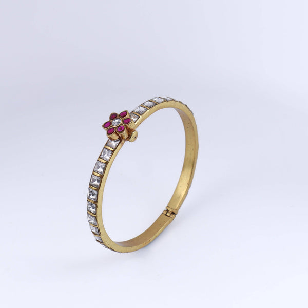 Angled view of a 22K gold-plated fashion bangle (single) highlighting its elegant structure, unique design, and polished gold finish