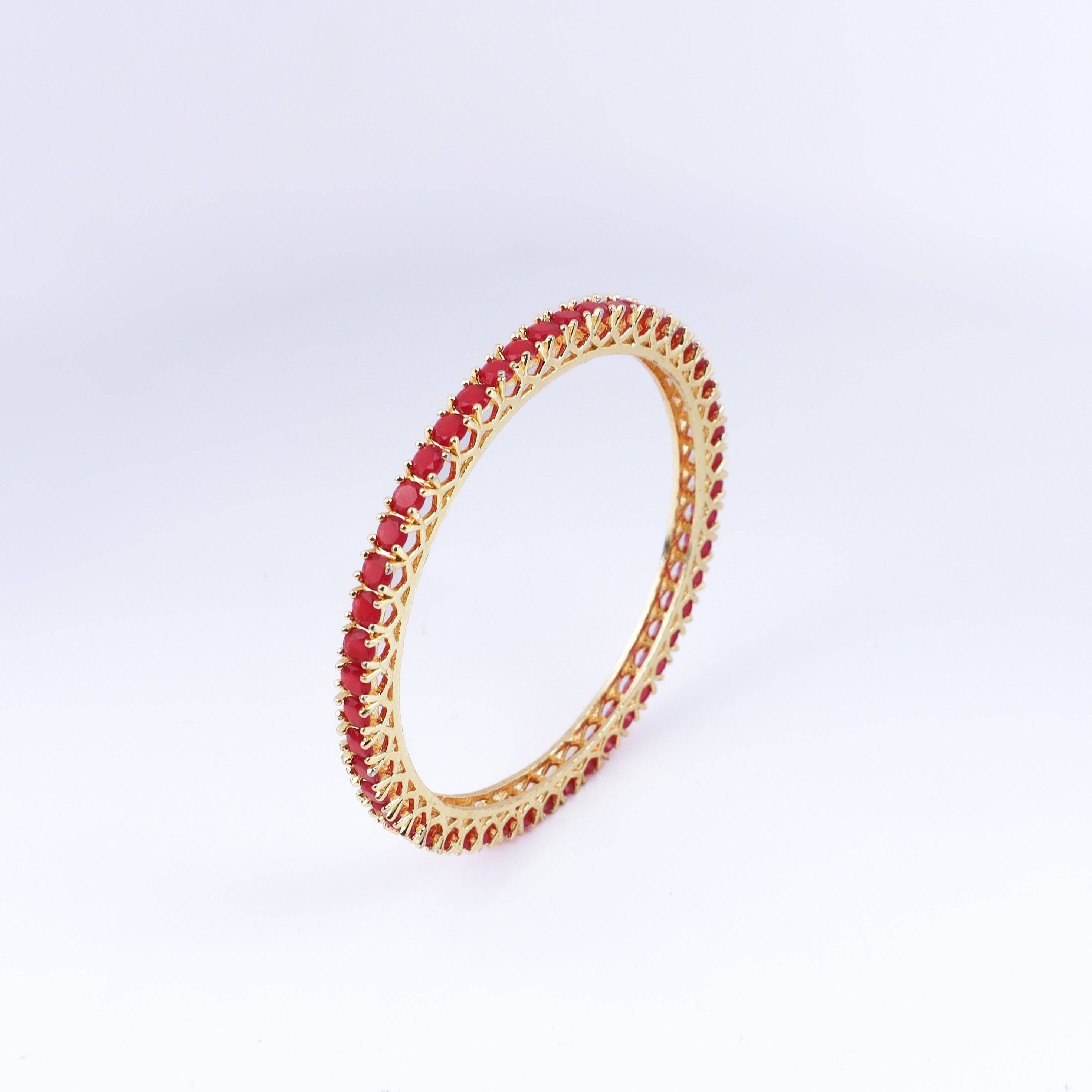 Angled view of a 22K gold-plated fashion bangle (single) highlighting its elegant structure and polished gold finish