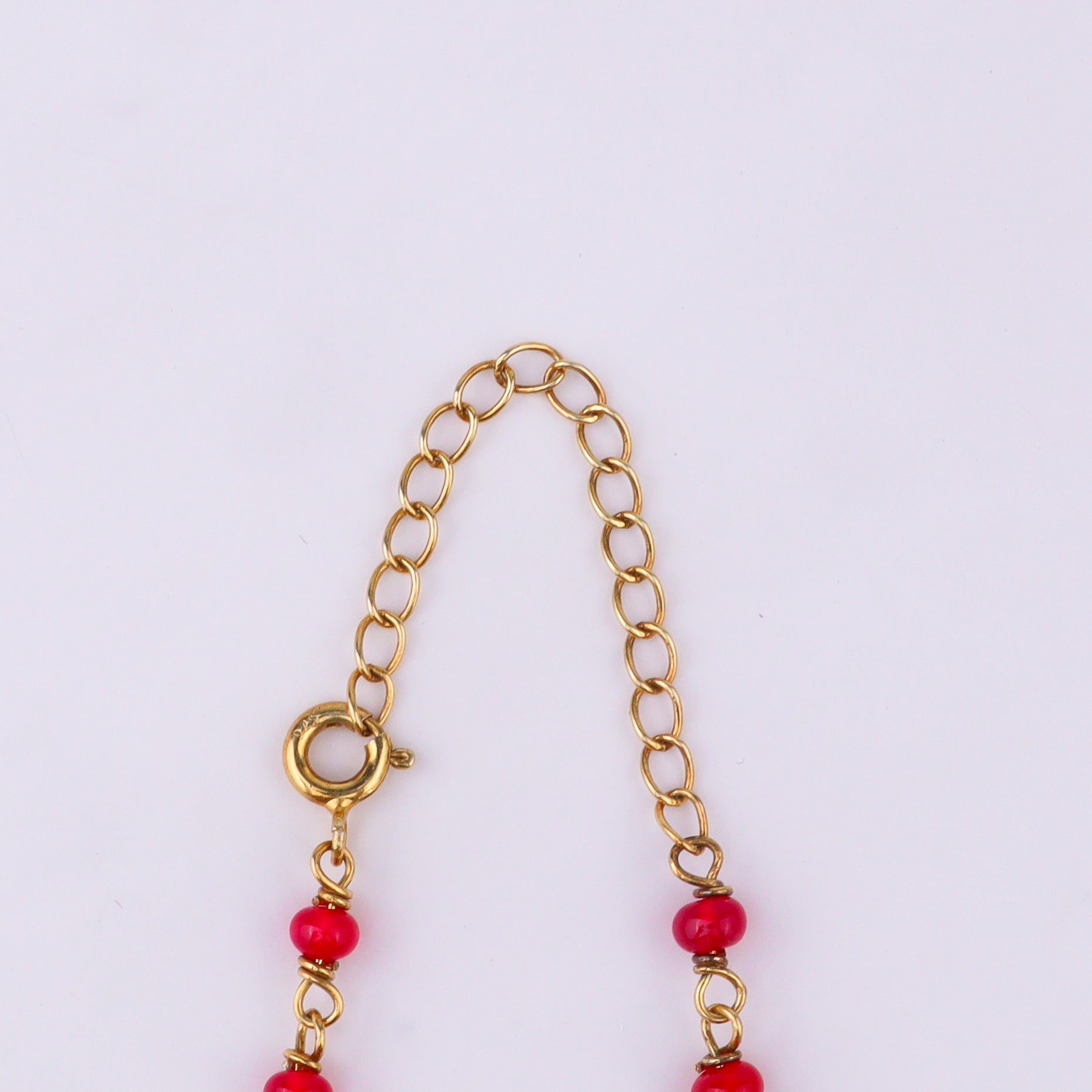 Gold chain with red beads