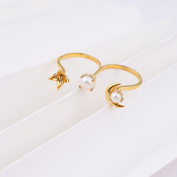 Gold moon and pearl ring on white background