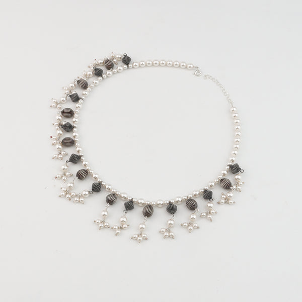 Detailed view of pearl and oxidized bead necklace