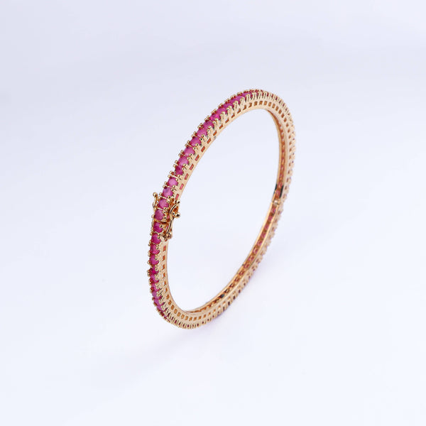 Angled view of a 22K gold-plated fashion bangle (single) highlighting its elegant structure, unique design, and polished gold finish