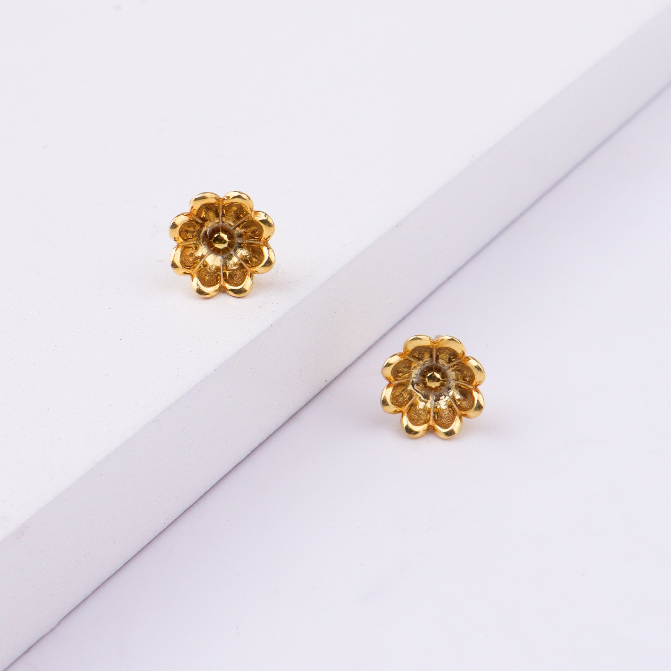 Gold flower earrings with white background