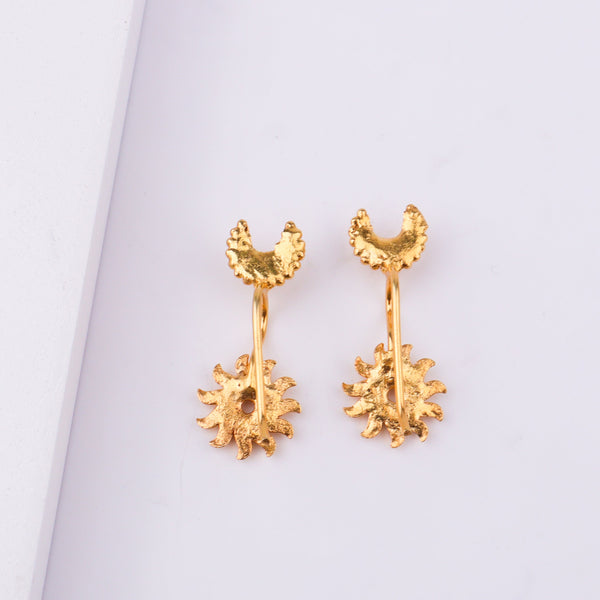 Gold moon earrings with beaded border on white backdrop