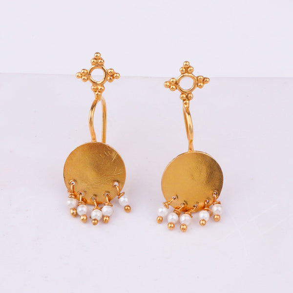 Gold earrings with circular pendant and pearl dangles displayed on white background