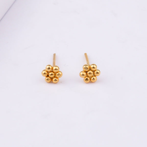 Gold earrings on white background