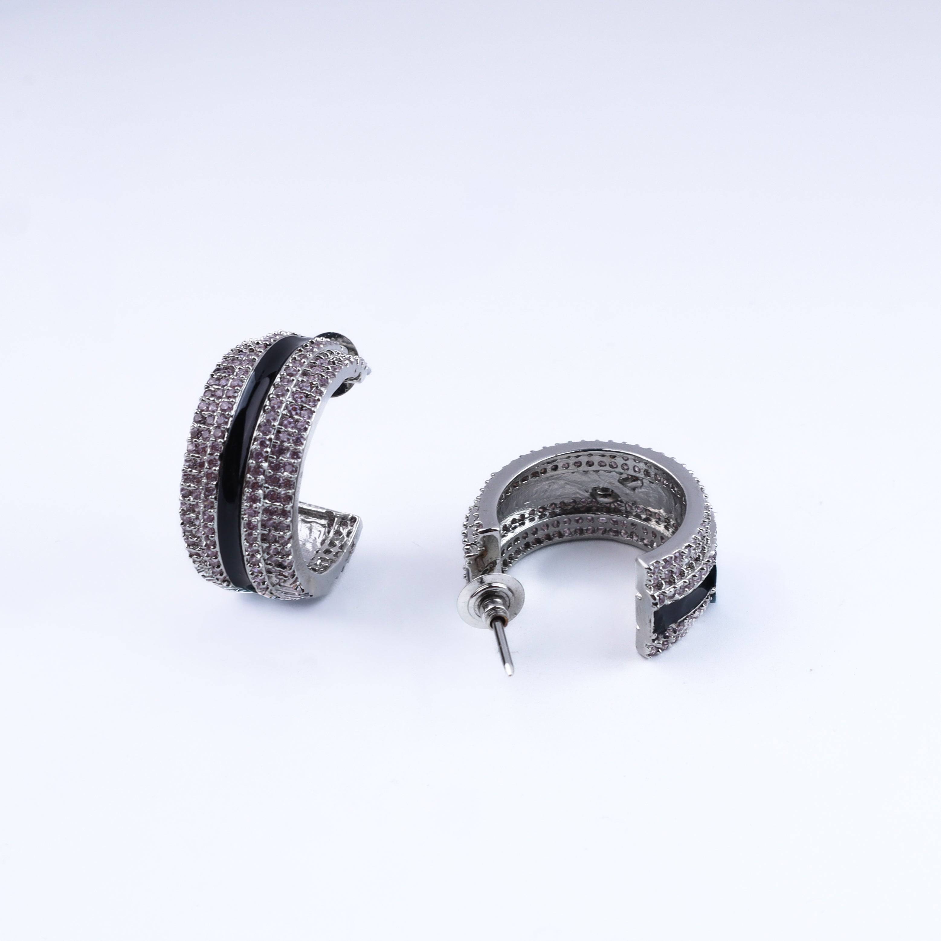 Angled view of the fashion earring highlighting its unique silhouette, structure, and polished finish